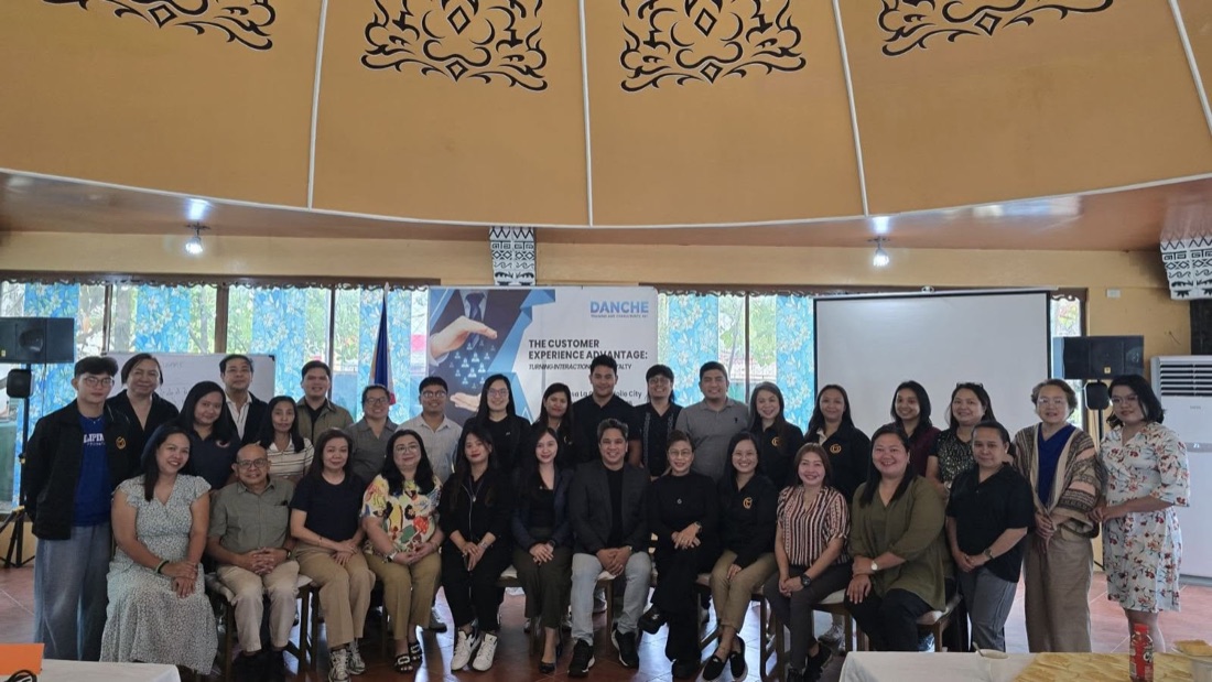 Agency cohort group photo with the DANCHE event banner